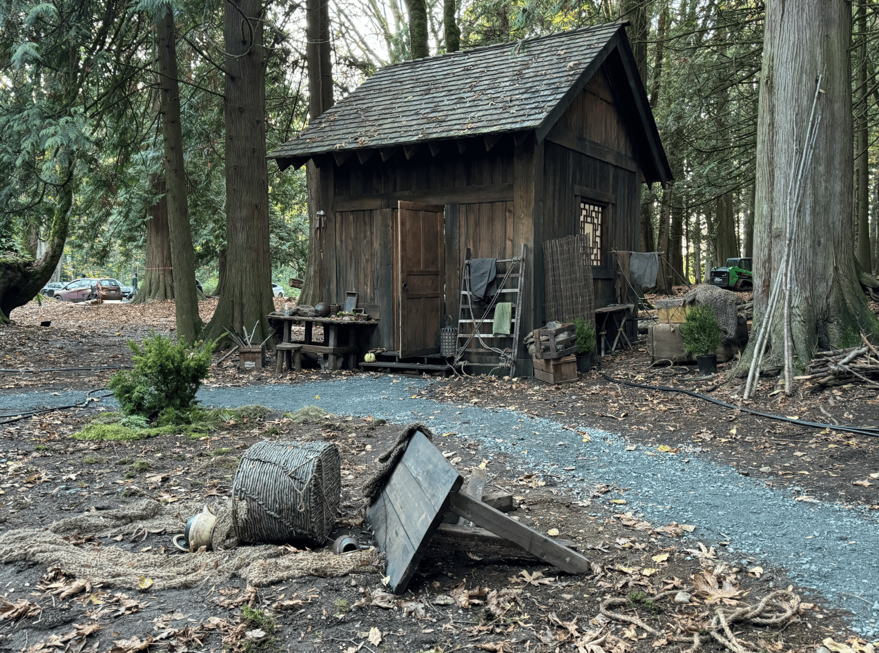 Cabin with fallen barrel in woods